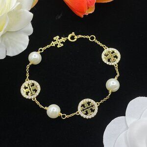 Tory Burch's new pearl bracelet, a stylish accessory for couples.
